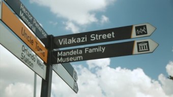 238440898-desmond-tutu-nelson-mandela-soweto-signpost
